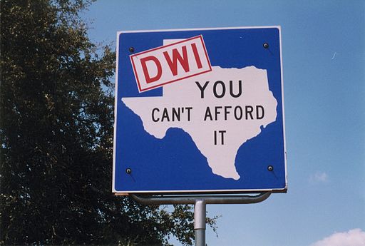 Warning road sign for DWI in Texas "DWI- You Can't Afford It"