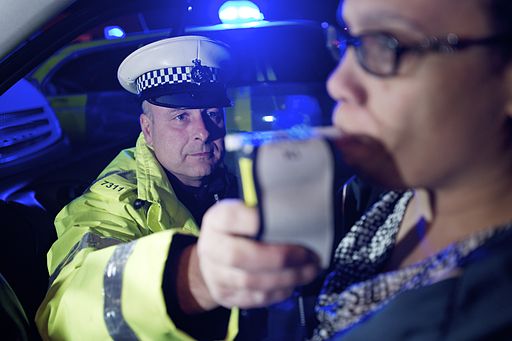 Officer administering breathalyzer to a woman